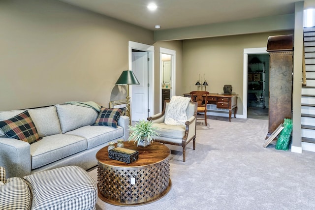 carpeted living room with recessed lighting, stairs, and baseboards
