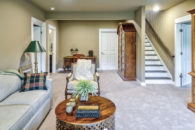 carpeted living room with stairs and baseboards