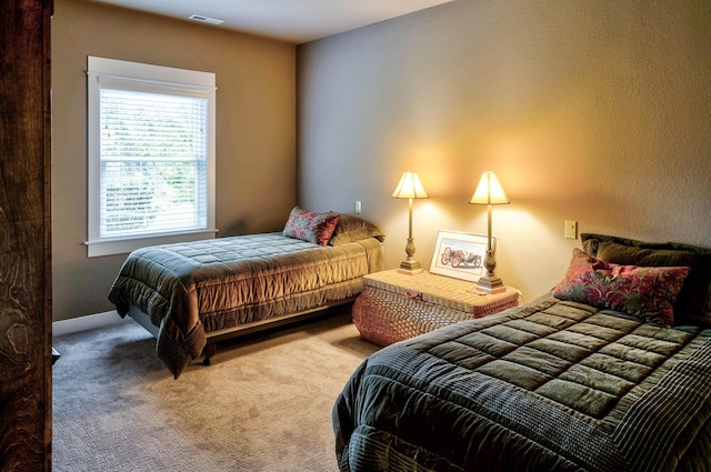 bedroom with visible vents and carpet floors