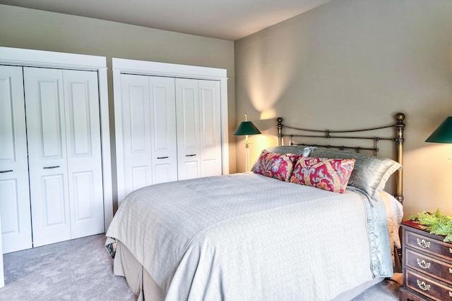 carpeted bedroom with multiple closets