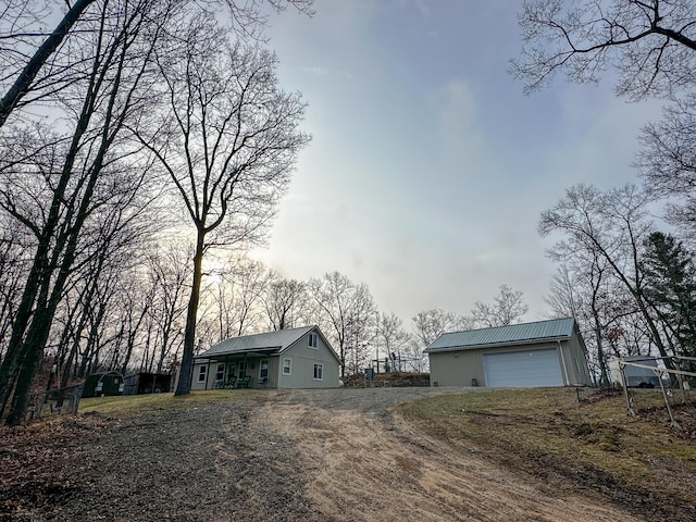 view of front of home featuring an outbuilding and dirt driveway