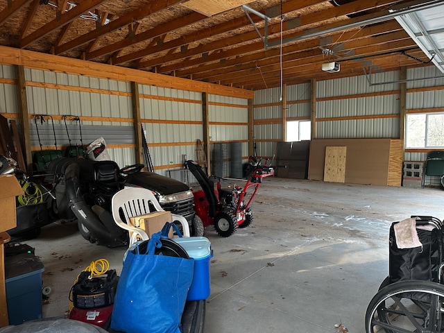 garage featuring a garage door opener and metal wall