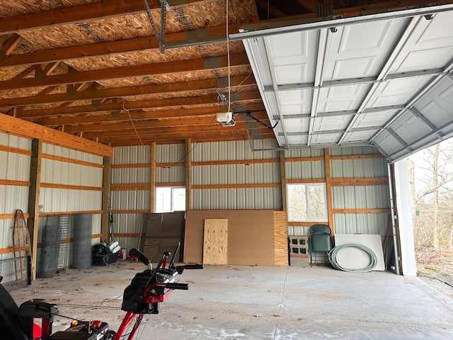 garage with a garage door opener and metal wall