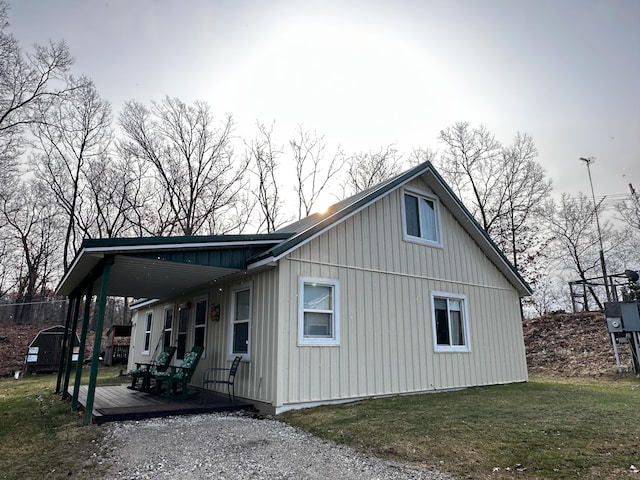 view of property exterior featuring board and batten siding and a lawn