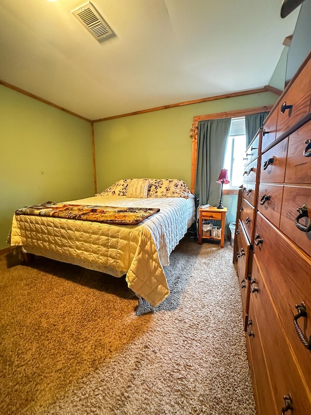 carpeted bedroom with crown molding and visible vents
