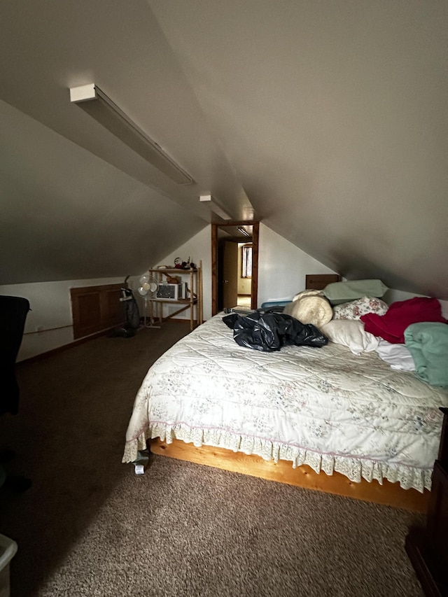 bedroom featuring dark colored carpet and lofted ceiling