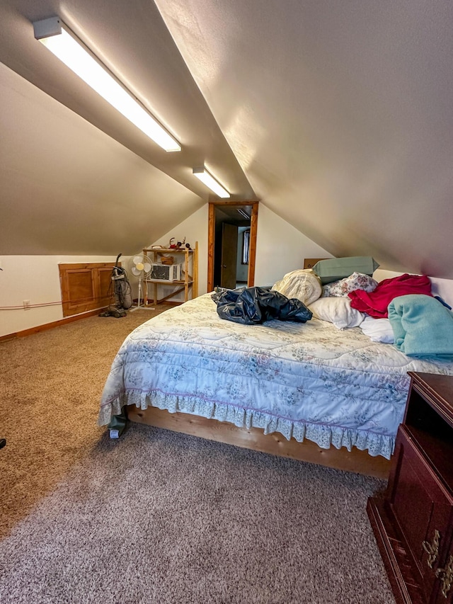 bedroom featuring carpet flooring, baseboards, and lofted ceiling