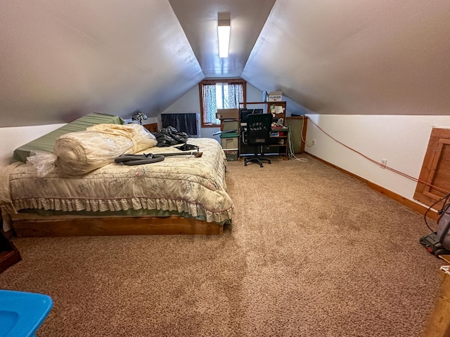 carpeted bedroom with baseboards and lofted ceiling