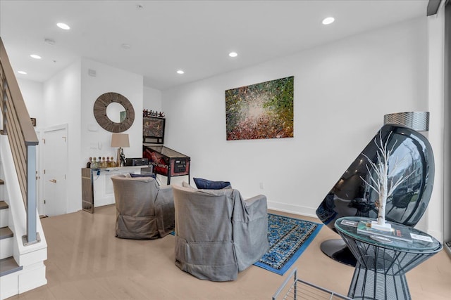 living area featuring recessed lighting and stairs