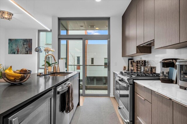 229 Alfred St, Detroit, MI 48201 - kitchen with appliances with stainless steel finishes, a sink, modern cabinets, light stone counters, and recessed lighting