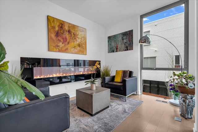 living room with visible vents and wood finished floors