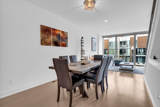 dining room featuring recessed lighting, visible vents, baseboards, and wood finished floors