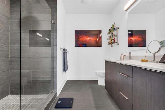 full bathroom with vanity, baseboards, tile patterned flooring, toilet, and tiled shower