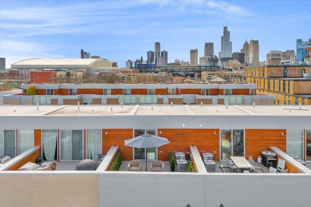 exterior space featuring an outdoor living space, a city view, and outdoor dining area