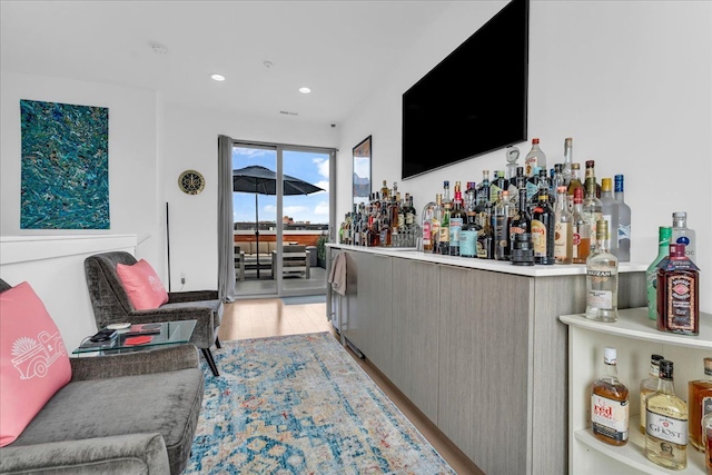 bar featuring recessed lighting, light wood-style floors, and a dry bar