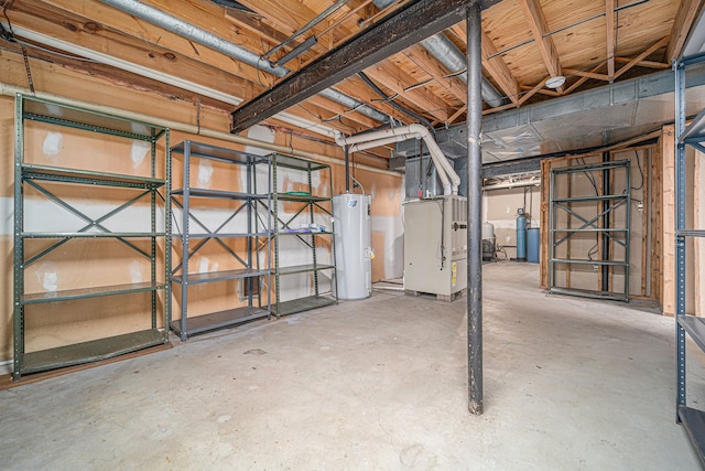 unfinished below grade area featuring heating unit and water heater