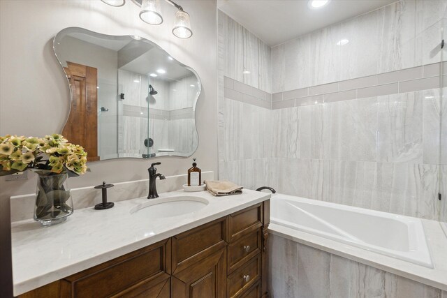 full bath with a shower, a bathtub, and vanity