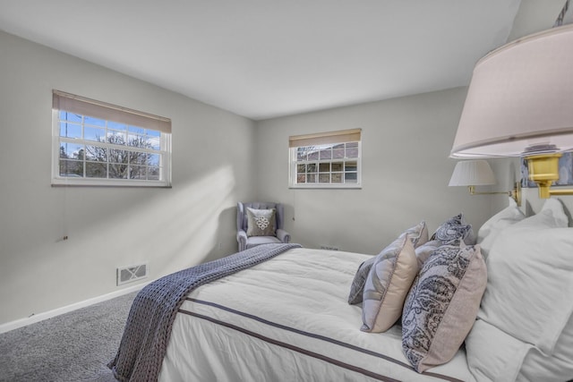 carpeted bedroom featuring visible vents and baseboards
