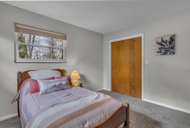 bedroom with carpet flooring and baseboards