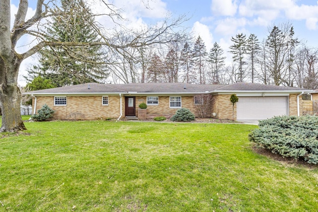 single story home with a front yard, an attached garage, and brick siding