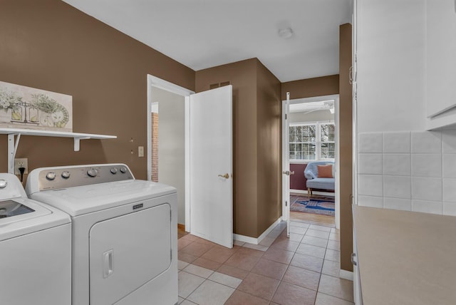 laundry room with baseboards, a ceiling fan, light tile patterned flooring, independent washer and dryer, and laundry area