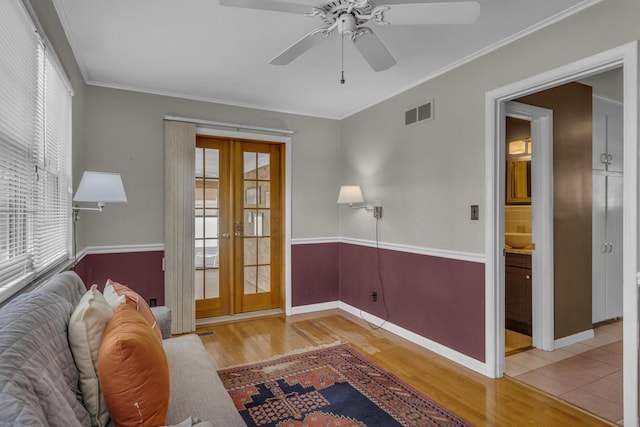 interior space with crown molding, french doors, wood finished floors, and a wealth of natural light