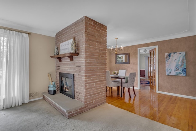 living room featuring wood finished floors, an inviting chandelier, baseboards, and visible vents