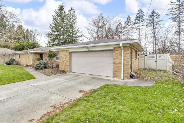 view of front of home with brick siding, a front yard, fence, a gate, and driveway