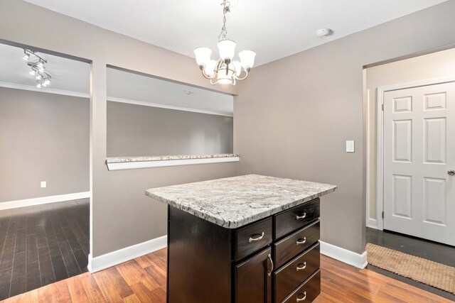 1985 Peerce, Canton, MI 48187 - kitchen featuring baseboards, an inviting chandelier, light countertops, pendant lighting, and wood finished floors