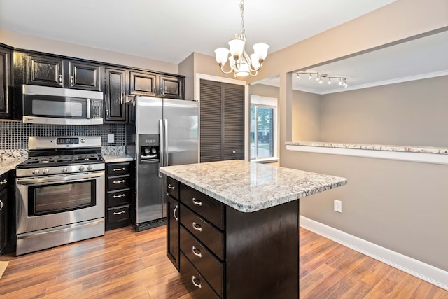1985 Peerce, Canton, MI 48187 - kitchen featuring baseboards, appliances with stainless steel finishes, a chandelier, light wood finished floors, and backsplash
