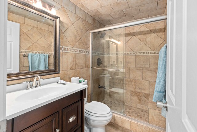 1985 Peerce, Canton, MI 48187 - bathroom with toilet, vanity, tile walls, and a stall shower