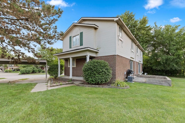 1985 Peerce, Canton, MI 48187 - view of front facade featuring brick siding, a detached carport, and a front lawn