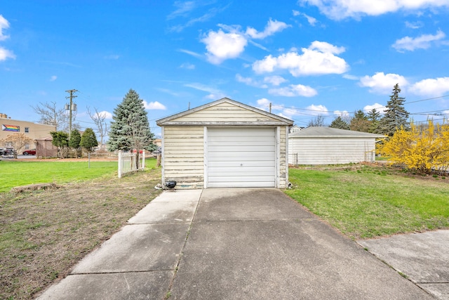 detached garage featuring concrete driveway