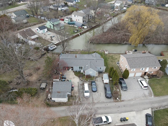 drone / aerial view with a residential view and a water view