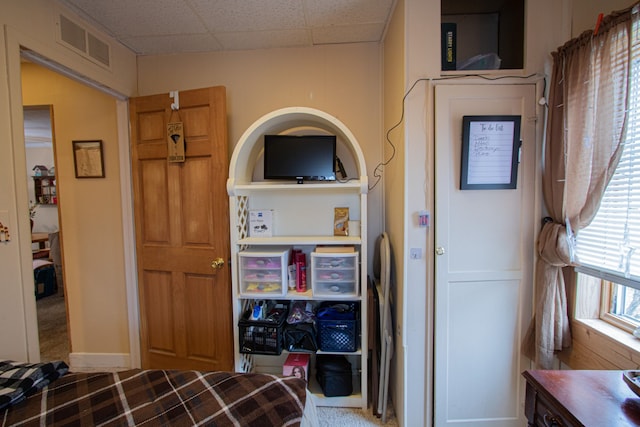 bedroom featuring visible vents and a paneled ceiling