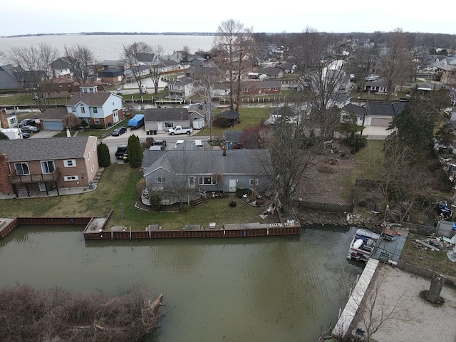 drone / aerial view featuring a residential view and a water view