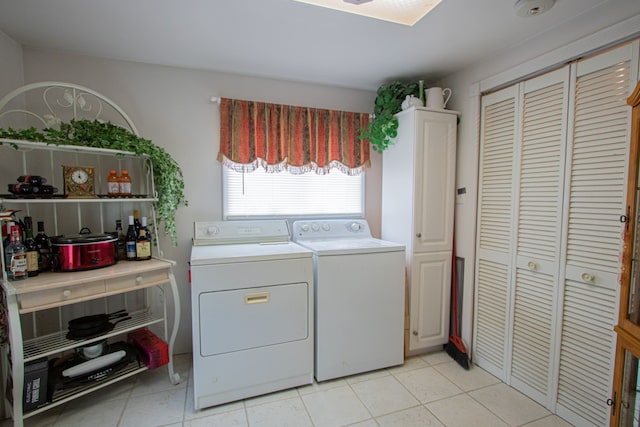 laundry area featuring light tile patterned floors and independent washer and dryer