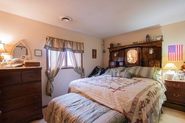 carpeted bedroom featuring visible vents
