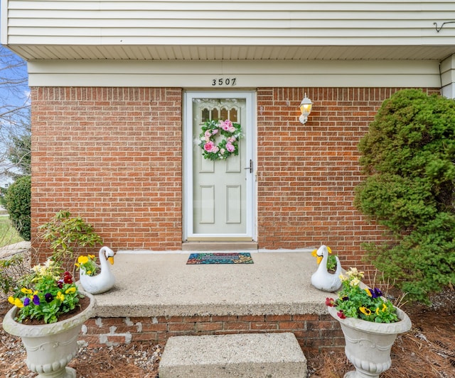 entrance to property with brick siding