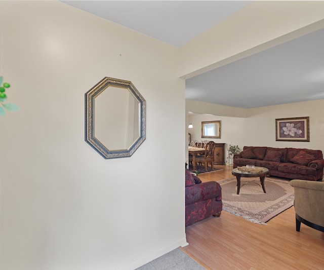 living room with baseboards and wood finished floors