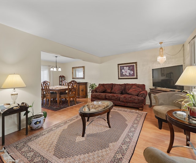 living area featuring light wood-style flooring and baseboards