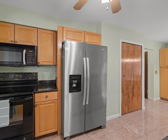 kitchen featuring dark stone countertops, ceiling fan, baseboards, and black appliances