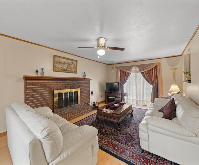 living area featuring ornamental molding, ceiling fan, and wood finished floors