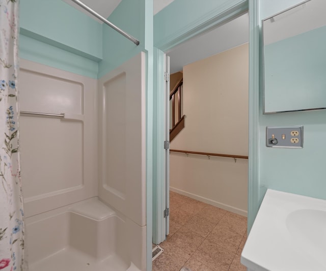 full bath featuring visible vents, baseboards, a stall shower, and vanity