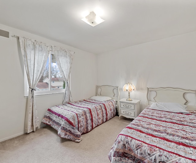 bedroom with visible vents and carpet