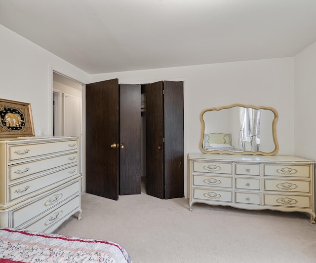 bedroom with a closet and light colored carpet