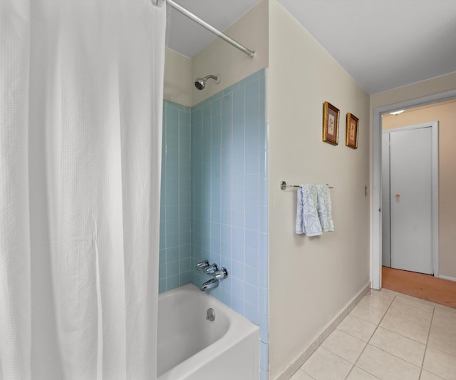 bathroom featuring shower / bath combo, tile patterned floors, and baseboards