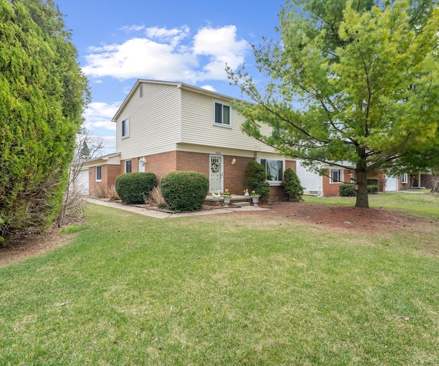 traditional-style home with brick siding and a front lawn