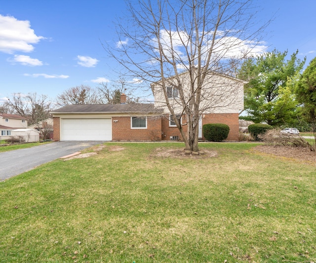 traditional-style house with a chimney, driveway, a front lawn, brick siding, and a garage