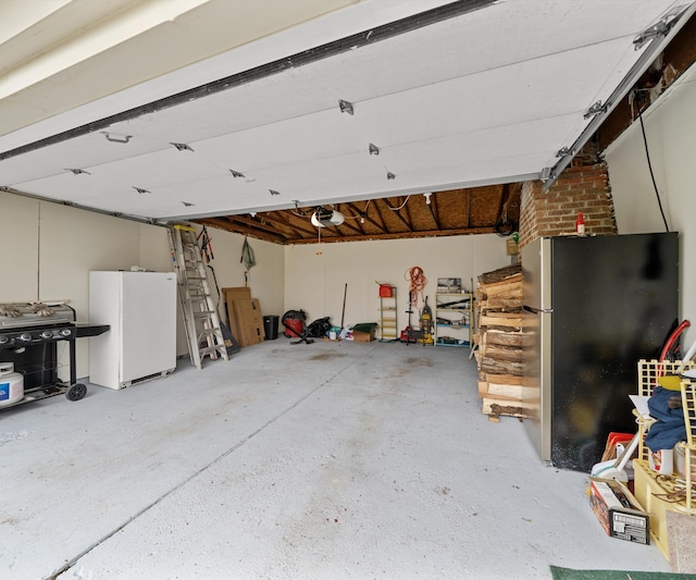 garage featuring a garage door opener and freestanding refrigerator